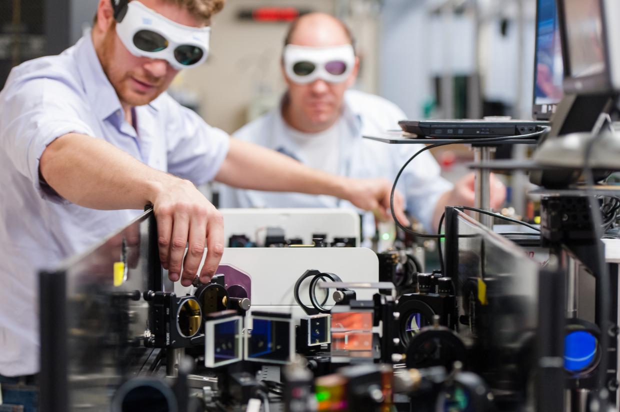 Two people with goggles in a lab.