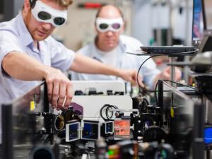 Two people with goggles in a lab.