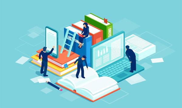 people working on a computer, a book, and a tablet